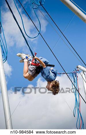 Preteen boy on a rubber band ride at a fair View Large Photo Image Picture - Preteen boy on a rubber band ride at a fair. Fotosearch