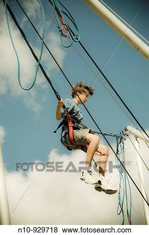 Preteen boy on a rubber band ride at a fair View Large Photo Image Stock Photo - Preteen boy on a rubber band ride at a fair. Fotosearch