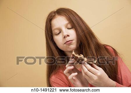 Preteen girl eating a bagel View Large Photo Image Stock Image - Preteen girl eating a bagel. Fotosearch