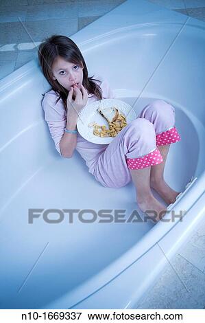 Preteen girl eating lunch in a bathtub View Large Photo Image Stock Photo - Preteen girl eating lunch in a bathtub. Fotosearch