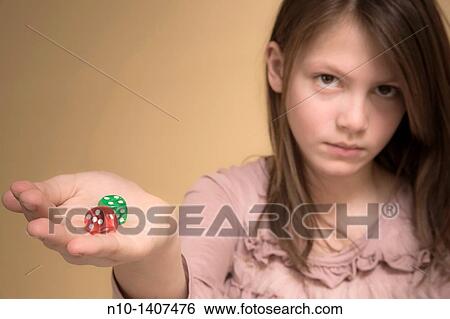 Preteen girl holding colored dice View Large Photo Image Stock Photograph - Preteen girl holding colored dice. Fotosearch