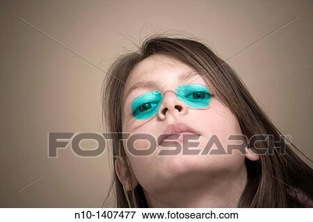 Preteen girl wearing old-fashioned glasses View Large Photo Image Stock Photo - Preteen girl wearing old-fashioned glasses. Fotosearch