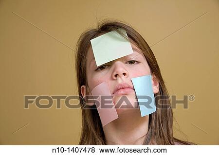 Preteen girl with post-it notes on her face View Large Photo Image Stock Photo - Preteen girl with post-it notes on her face. Fotosearch