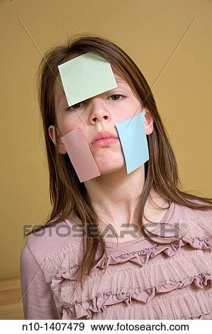 Preteen girl with post-it notes on her face View Large Photo Image Stock Photo - Preteen girl with post-it notes on her face. Fotosearch