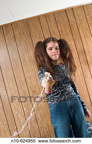 Preteen girl, with two large ponytails, squirting liquid string. View Large Photo Image Stock Photography - Preteen girl, with two large ponytails, squirting liquid string.. Fotosearch