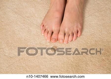 Preteen girl's feet next to a quarter View Large Photo Image Stock Photograph - Preteen girl's feet next to a quarter. Fotosearch