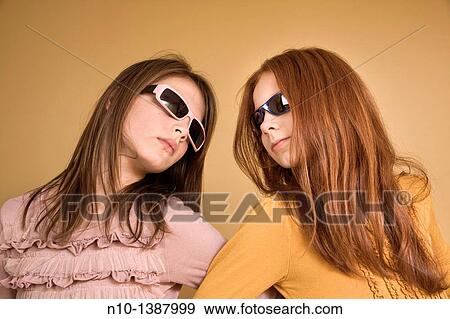 Preteen girls wearing sunglasses View Large Photo Image Stock Photo - Preteen girls wearing sunglasses. Fotosearch