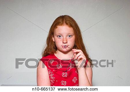 Preteen redhead girl holding a pair of glasses. View Large Photo Image Stock Photo - Preteen redhead girl holding a pair of glasses.. Fotosearch