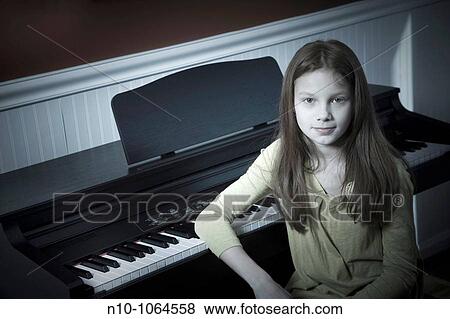 Preteen redhead girl sitting at an electric piano View Large Photo Image Stock Photo - Preteen redhead girl sitting at an electric piano. Fotosearch