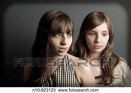 Preteen twin sisters posing. View Large Photo Image Stock Image - Preteen twin sisters posing.. Fotosearch