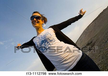 Pretending to fly happy young woman View Large Photo Image Stock Photo - Pretending to fly happy young woman. Fotosearch