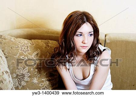 pretty blond female wearing evening pink gown sitting on sofa watching television View Large Photo Image Stock Photo - pretty blond female wearing evening pink gown sitting on sofa watching television. Fotosearch