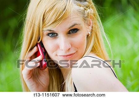 Pretty blonde teen girl is using a cellular phone View Large Photo Image Stock Photo - Pretty blonde teen girl is using a cellular phone. Fotosearch