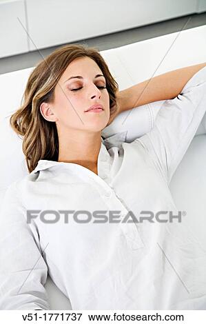 Pretty blonde woman enjoying a nap on the sofa View Large Photo Image Stock Photo - Pretty blonde woman enjoying a nap on the sofa. Fotosearch