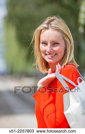 Pretty blonde woman happy with her shopping bag View Large Photo Image Stock Image - Pretty blonde woman happy with her shopping bag. Fotosearch