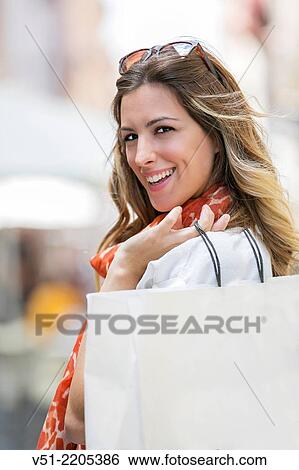 Pretty blonde woman happy with her shopping bag View Large Photo Image Stock Photograph - Pretty blonde woman happy with her shopping bag. Fotosearch