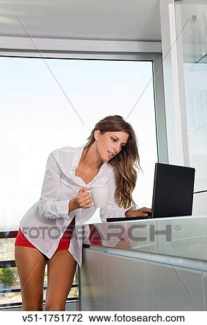Pretty blonde woman with coffee and laptop in the morning at the kitchen View Large Photo Image Stock Image - Pretty blonde woman with coffee and laptop in the morning at the kitchen. Fotosearch
