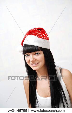 pretty brunette girl in Santa hat indoors View Large Photo Image Stock Image - pretty brunette girl in Santa hat indoors. Fotosearch