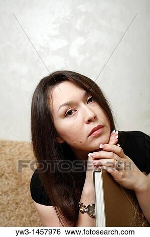 pretty brunette girl indoors on modern sofa View Large Photo Image Stock Photograph - pretty brunette girl indoors on modern sofa. Fotosearch