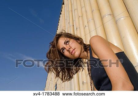 Pretty Brunette posed in bamboo background at Ebro riverside at ExpoZaragoza outdoors area, Saragossa, Aragon, Spain View Large Photo Image Stock Photo - Pretty Brunette posed in bamboo background at Ebro riverside at ExpoZaragoza outdoors area, Saragossa, Aragon, Spain. Fotosearch