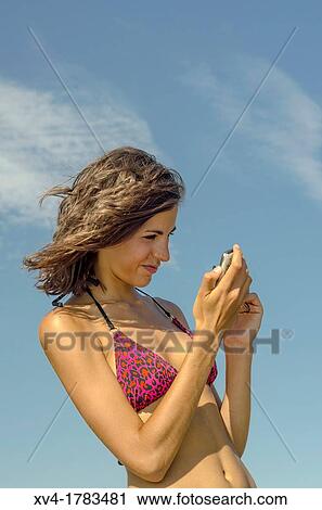 Pretty Brunette talk with mobile phone at Ebro riverside at ExpoZaragoza outdoors area, Saragossa, Aragon, Spain View Large Photo Image Stock Image - Pretty Brunette talk with mobile phone at Ebro riverside at ExpoZaragoza outdoors area, Saragossa, Aragon, Spain. Fotosearch