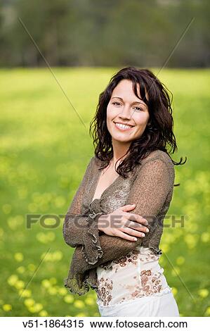 Pretty brunette woman in countryside smiling at camera View Large Photo Image Stock Photography - Pretty brunette woman in countryside smiling at camera. Fotosearch