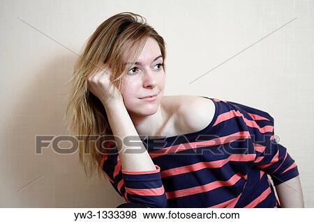 Stock Photo - pretty girl against light wall blank expression. Fotosearch