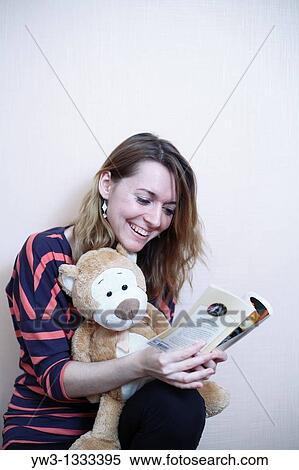 pretty girl against light wall with book and teddy bear View Large Photo Image Stock Photography - pretty girl against light wall with book and teddy bear. Fotosearch