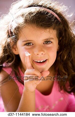 Pretty girl applying facial cream View Large Photo Image Picture - Pretty girl applying facial cream. Fotosearch