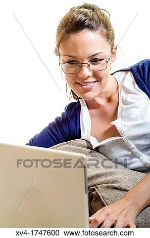 Pretty girl chatting on notebook in the bedroom View Large Photo Image Stock Image - Pretty girl chatting on notebook in the bedroom. Fotosearch