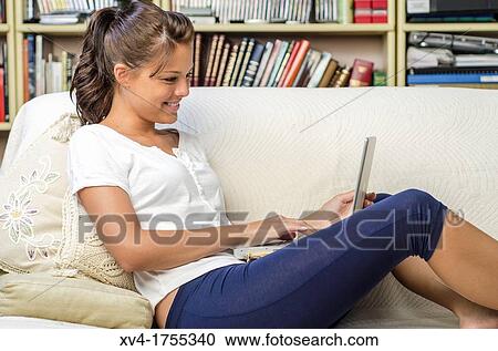 Pretty girl chatting on notebook in the bedroom View Large Photo Image Stock Image - Pretty girl chatting on notebook in the bedroom. Fotosearch