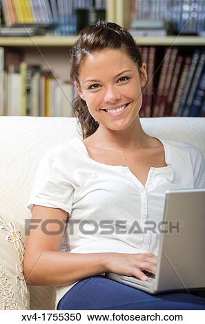 Pretty girl chatting on notebook in the bedroom View Large Photo Image Stock Image - Pretty girl chatting on notebook in the bedroom. Fotosearch