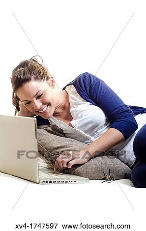 Pretty girl chatting on notebook in the bedroom View Large Photo Image Stock Photo - Pretty girl chatting on notebook in the bedroom. Fotosearch