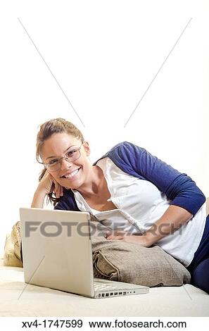 Pretty girl chatting on notebook in the bedroom View Large Photo Image Stock Photo - Pretty girl chatting on notebook in the bedroom. Fotosearch