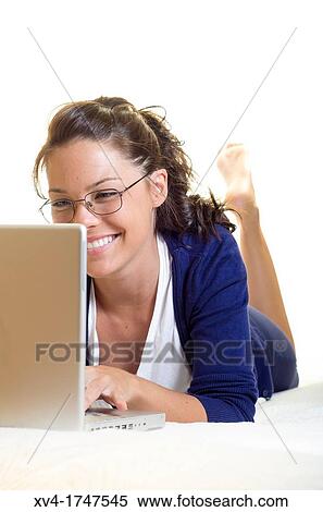Pretty girl chatting on notebook in the bedroom View Large Photo Image Stock Photography - Pretty girl chatting on notebook in the bedroom. Fotosearch