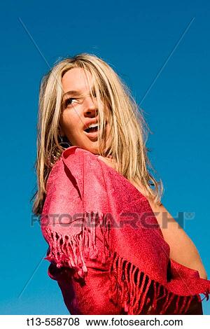 Pretty girl dressed in red, isolated on blue sky background View Large Photo Image Stock Photo - Pretty girl dressed in red, isolated on blue sky background. Fotosearch