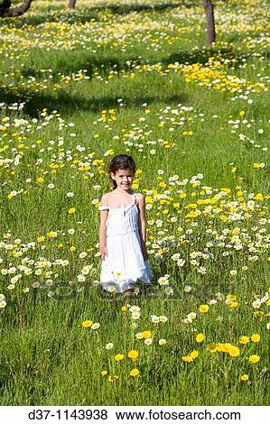 Pretty girl in a flower field View Large Photo Image Stock Photo - Pretty girl in a flower field. Fotosearch
