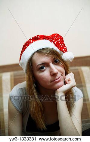pretty girl in the Christmas hat on sofa View Large Photo Image Stock Image - pretty girl in the Christmas hat on sofa. Fotosearch