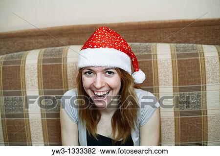 pretty girl in the Christmas hat against light wall smiling View Large Photo Image Stock Image - pretty girl in the Christmas hat against light wall smiling. Fotosearch