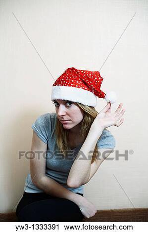 pretty girl in the Christmas hat against light wall posing View Large Photo Image Stock Image - pretty girl in the Christmas hat against light wall posing. Fotosearch