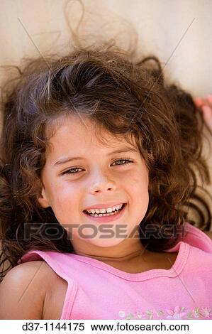 Pretty girl laughing and holding a cuddly toy View Large Photo Image Stock Photography - Pretty girl laughing and holding a cuddly toy. Fotosearch