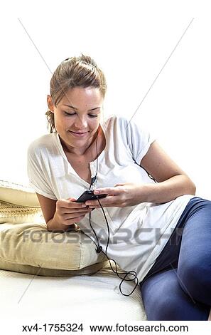 Pretty girl listening music in the bedroom View Large Photo Image Picture - Pretty girl listening music in the bedroom. Fotosearch
