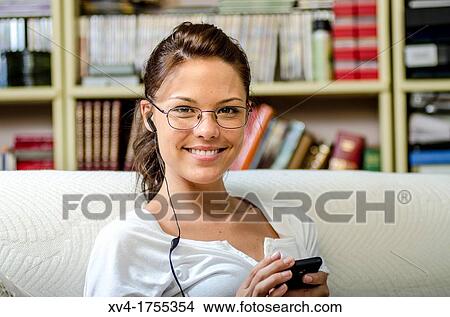 Pretty girl listening music in the bedroom View Large Photo Image Picture - Pretty girl listening music in the bedroom. Fotosearch