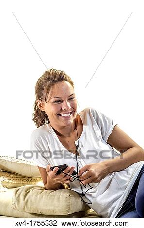 Pretty girl listening music in the bedroom View Large Photo Image Stock Image - Pretty girl listening music in the bedroom. Fotosearch