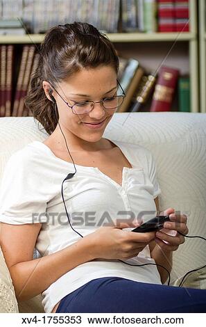 Pretty girl listening music in the bedroom View Large Photo Image Stock Image - Pretty girl listening music in the bedroom. Fotosearch