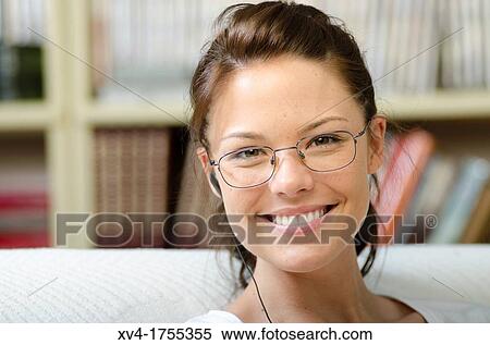 Stock Photography - Pretty girl listening music in the bedroom. Fotosearch