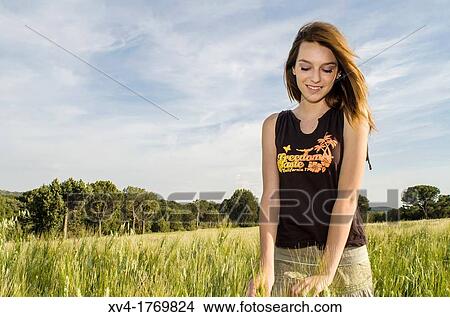 Pretty girl relaxing and enjoy in the wheat field View Large Photo Image Picture - Pretty girl relaxing and enjoy in the wheat field. Fotosearch