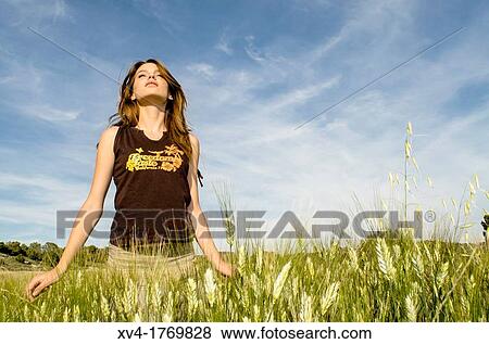 Pretty girl relaxing and enjoy in the wheat field View Large Photo Image Stock Photo - Pretty girl relaxing and enjoy in the wheat field. Fotosearch