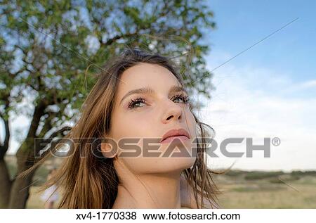 Pretty girl relaxing and enjoy in the wheat field and look at horizont View Large Photo Image Stock Photo - Pretty girl relaxing and enjoy in the wheat field and look at horizont. Fotosearch