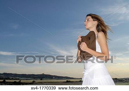 Pretty girl relaxing and enjoy in the wheat field and look at horizont View Large Photo Image Stock Photo - Pretty girl relaxing and enjoy in the wheat field and look at horizont. Fotosearch